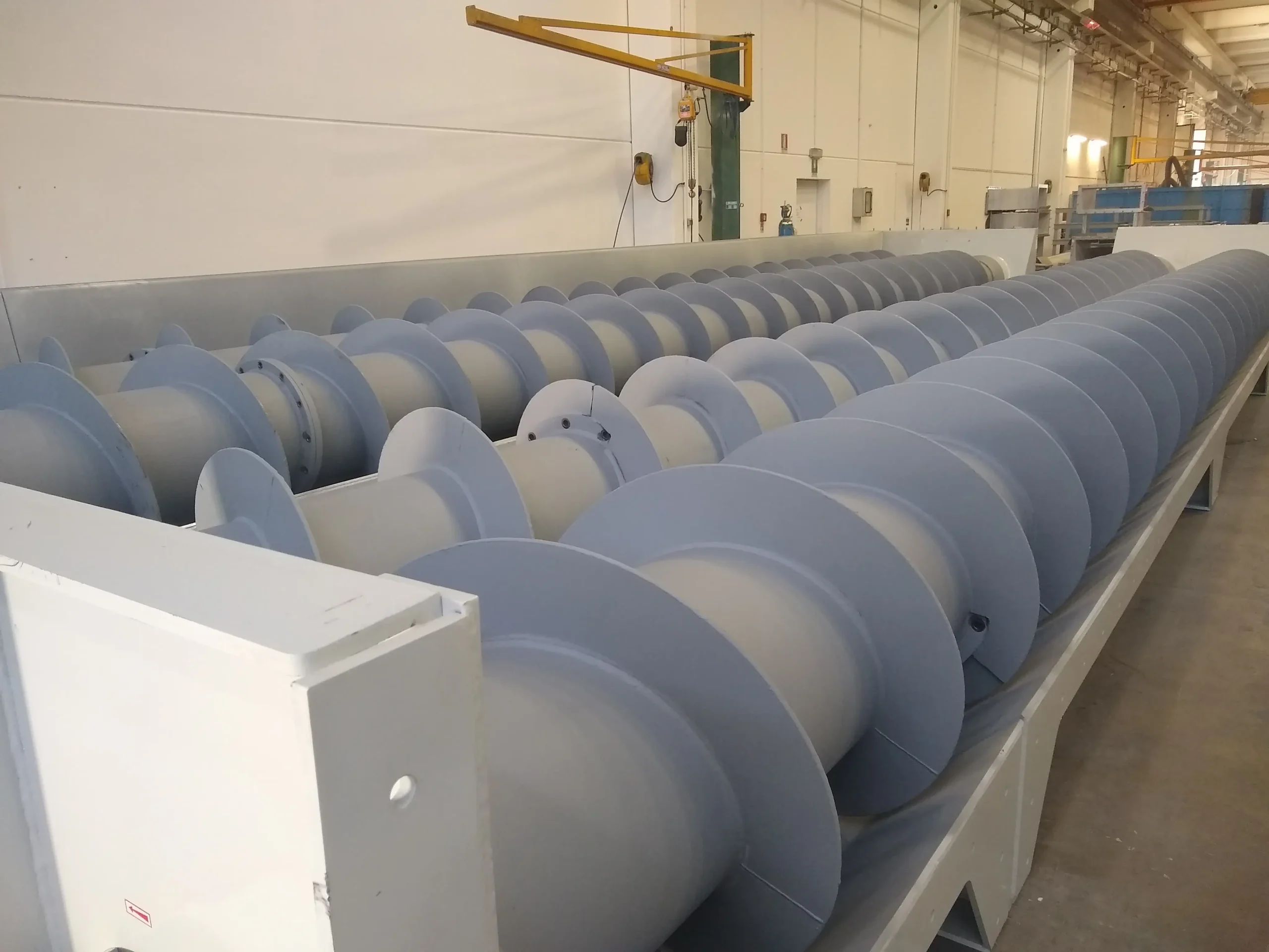 BUMATECH-Large-scale spiral screw conveyors lined up in metal casing inside production plant